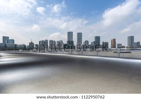 Panoramic skyline and modern business office buildings with empty road