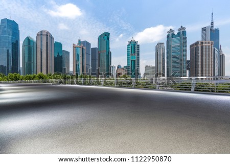 Panoramic skyline and modern business office buildings with empty road