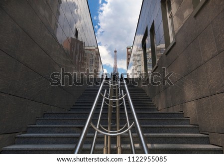 Steps and rails, blue sky with clouds, rhythm in photography, central composition.