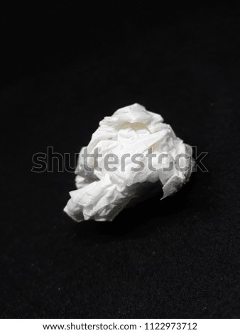 used screwed paper tissue isolated on Black Background