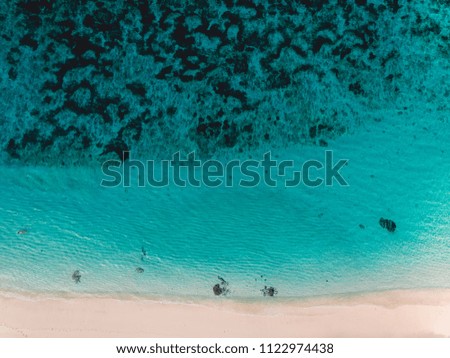 Top view of tropical beach with turquoise ocean water, aerial view