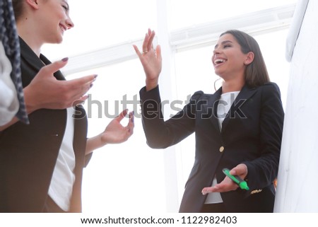 business woman pointing with a marker on the flipchart