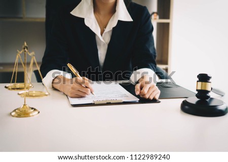 Professional female lawyers working at the law firms. Judge gavel with scales of justice. Legal law, lawyer, advice and justice concept. Royalty-Free Stock Photo #1122989240