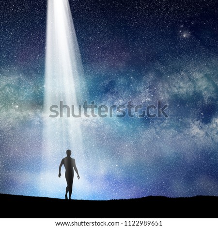 conceptual image of silhouetted man and abstract universe lights. 