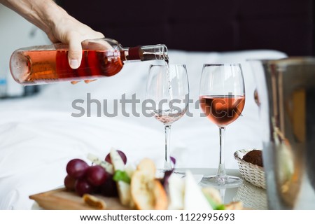 Two glass of rose wine and cheese board (selective focus) Royalty-Free Stock Photo #1122995693