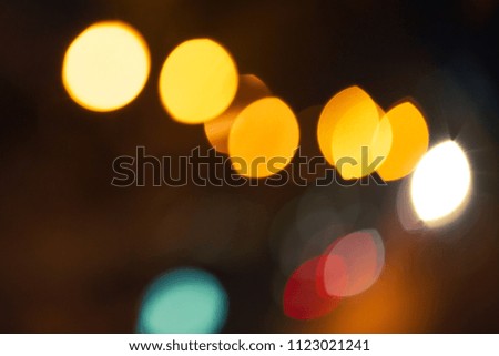 blurred bokeh, bright light sources in the form of a cat's eye
against a dark background
