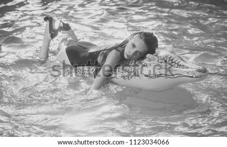 Beauty Fashion model girl. Fashion look. girl on inflatable mattress crocodile in the pool