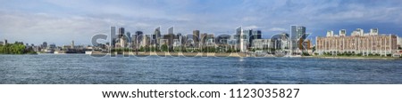 Gorgeous skyline of Montreal as seen across the St. Lawrence River on a sunny day. Montreal, Quebec, Canada.