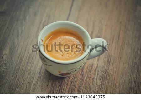 espresso shot very nice  golden crema on wooden table at cafe 