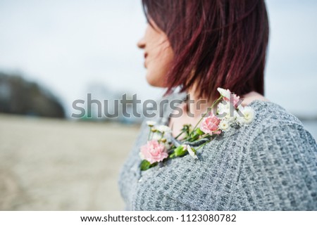 Portrait of brunette girl in gray dress background the lake.
