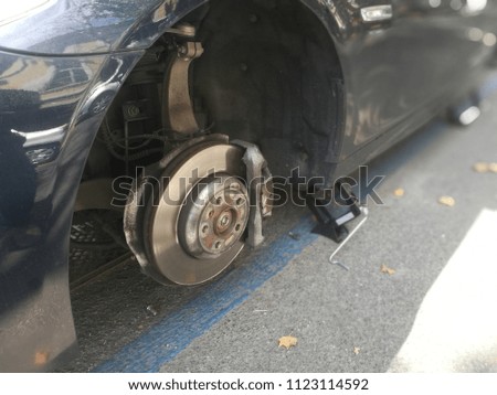 Car in the Street without Tyres Robbed by a Thief on Bricks