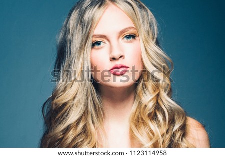 Blonde female with beautiful long curly  blond haierstyle