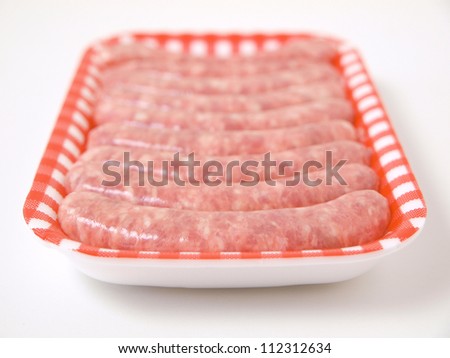 Fresh sausages on a tray. The photo is taken with studio light, isolated on white background.