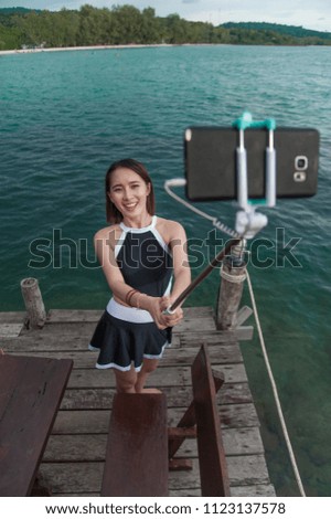 Young woman making selfie in the sea water, Selfie on the beach