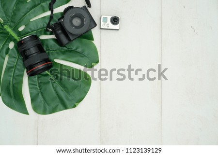 Set of modern photographic equipment on white wooden table, top view.
