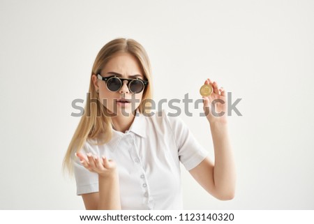 beautiful woman new-fashioned double-sided glasses holds a coin in her hand, Bitcoin                             