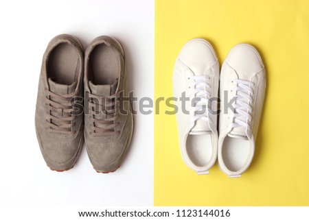 male sneakers and sneakers on a colored background top view. men's footwear. minimalism
