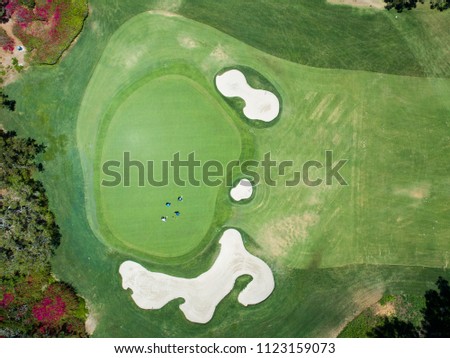 Aerial photograph of a golf course in a resort area.