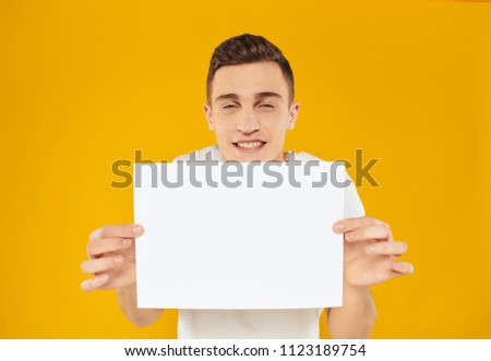 man on a yellow background and clean sheet of paper                             