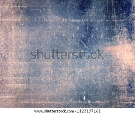 Designed grungy medium format film background with heavy grain, dust and light leak