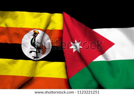 Uganda and Jordan flag on cloth texture