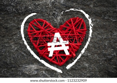 Love of money. Argentina Austral symbol on a red heart. Love theme
