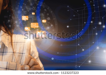   closeup of woman's finger up with modern 
 new technology  icons on computer notebook ,mobile phone.