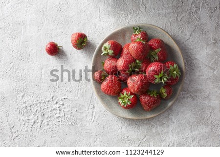 Strawberries in a gray ceramic plate. Top view