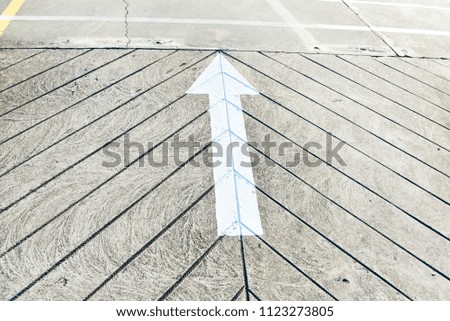 White arrow sign on the street, Direction for traffic safety .
