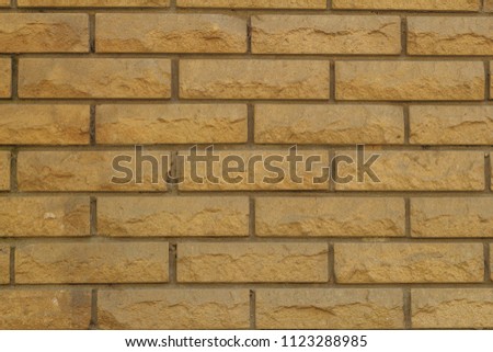 Background of a wall made of bricks made of sandstone texture
