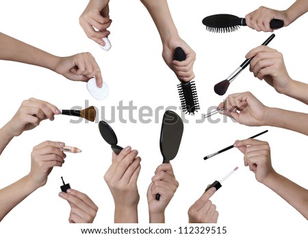many hands holding different  make up equipment cut out on white background Royalty-Free Stock Photo #112329515