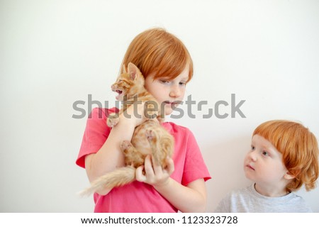 Girl holding a ginger kitten