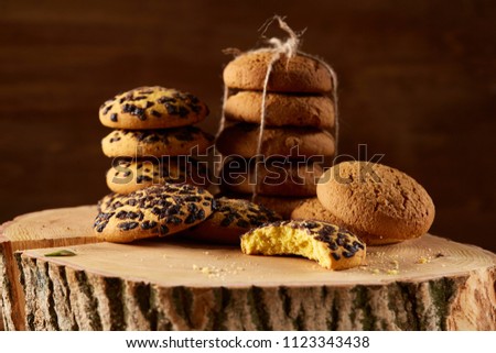 Traditional Christmas tea concept with dried oranges, cookies and decorations on a wooden table, selective focus