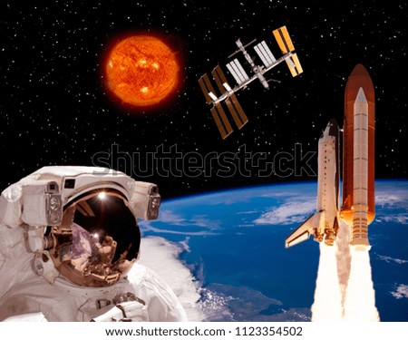 Astronaut looks at the space station. The elements of this image furnished by NASA.
