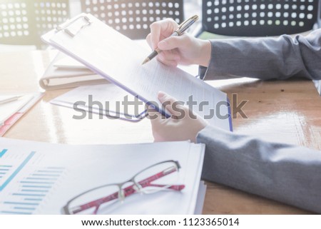 Administrator business man financial inspector and secretary making report, calculating or checking balance.