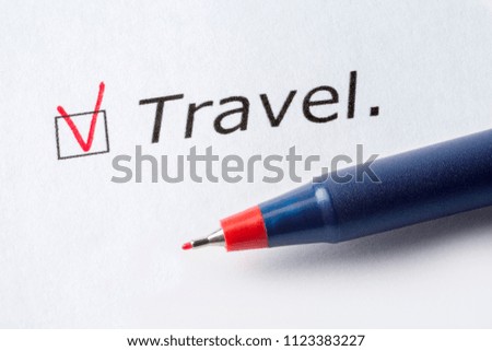 The word travel is printed on a white background. Check mark in red, marked in the square.