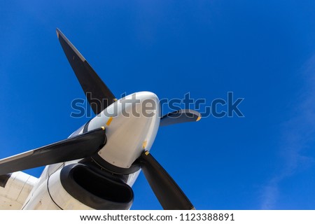 bottom view of aircraft propeller blade and turboprop engines with blue sky background and copy space Royalty-Free Stock Photo #1123388891