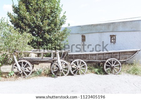 Old wheel wooden cart in Khortytsya. Cossaks residency Ukraine. Close up.