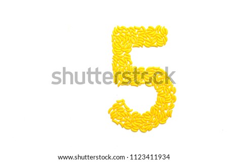 Number five made with banana candies on a white background