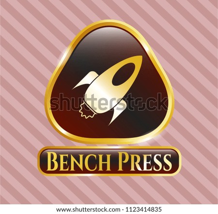  Golden emblem or badge with rocket icon and Bench Press text inside