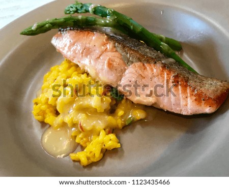 Plate of seared salmon with asparagus and yellow wild rice