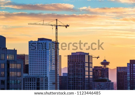 Sunset at Seattle skyline with construction cranes 