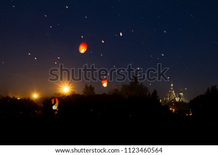 Prom on the Champ de Mars, flying lanterns against the background of the sky