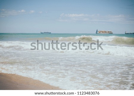 Photo of beautiful and inspirative ocean beach. Blue sky on warm summer day. Beautiful blue ocean wuth waves. 