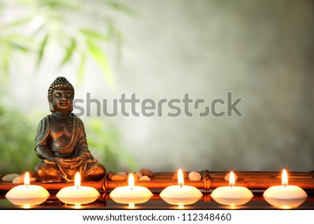 Buddha and candles, religious concept. Royalty-Free Stock Photo #112348460