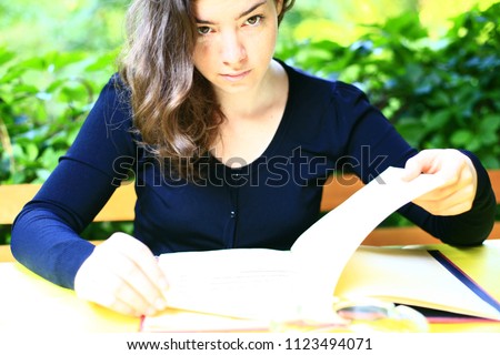 beautiful young woman in blue jacket by the desk