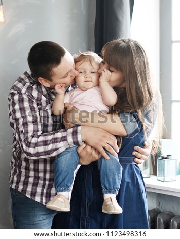 Dad, mom and daughter are together in the room.
