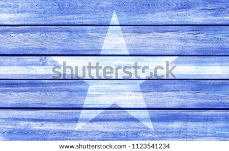 White star on blue painted wood background