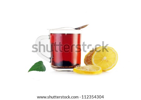 Full glass cup of tea and  lemon close up