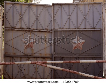 Photo background with metal gates and red stars